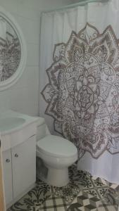 a bathroom with a toilet and a mandala shower curtain at casa reñaca sector jardín del mar in Viña del Mar +44 photos