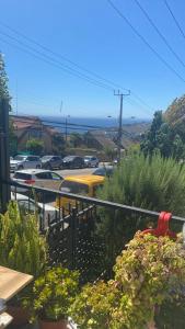 a view of a parking lot with a yellow bus at casa reñaca sector jardín del mar in Viña del Mar
