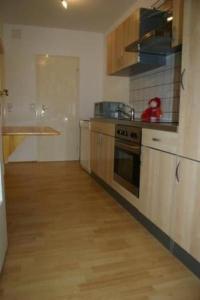 a kitchen with wooden floors and a counter top at Apartment Lotta in Trochtelfingen by Interhome in Trochtelfingen