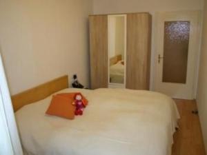 a small teddy bear sitting on a bed in a bedroom at Apartment Lotta in Trochtelfingen by Interhome in Trochtelfingen