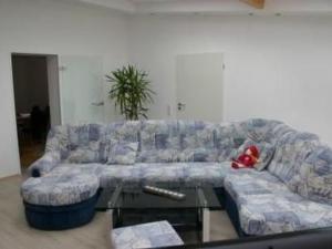 a living room with a couch and a table at Apartment Lotta in Trochtelfingen by Interhome in Trochtelfingen
