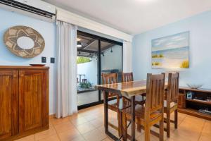 a dining room with a wooden table and chairs at Spacious Home with Private Pool & Covered Patio Near the Beach in Playa Flamingo