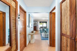 a hallway leading to a living room with a table at Spacious Home with Private Pool & Covered Patio Near the Beach in Playa Flamingo +23 photos