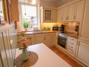 a kitchen with a table with a vase of flowers on it at Apartment Appartement mit Terrasse by Interhome in Bracht