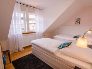 a bedroom with two beds and a window at Apartment Appartement mit Terrasse by Interhome in Bracht +2 photos