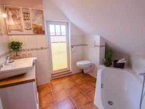 a bathroom with a tub and a toilet and a sink at Apartment Appartement mit Terrasse by Interhome in Bracht