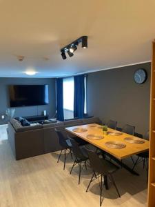 a living room with a table and a couch at IQ apartments 3 in Ytri-Njarðvík