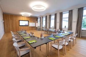 a large meeting room with a large table and chairs at KurOase im Kloster in Bad Wörishofen