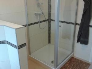 a shower with a glass door in a bathroom at Apartment 4 by Interhome in Feldhusen