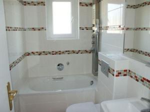 a bathroom with a tub and a toilet and a sink at Apartment Fe-Wohnung Augsburg by Interhome in Augsburg
