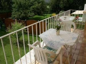 a white table and chairs on a balcony at Apartment Fe-Wohnung Augsburg by Interhome in Augsburg