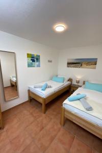 a room with two beds and a mirror at Apartment in Dassow by Interhome in Feldhusen