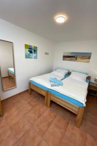 a bed in a room with a mirror and a bed at Apartment in Dassow by Interhome in Feldhusen