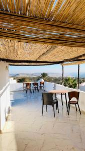 a patio with chairs and a table on a roof at Taghazout surf in Tamraght Ouzdar