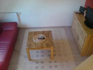 a living room with a red couch and a coffee table at Apartment 3 by Interhome in Feldhusen +3 photos
