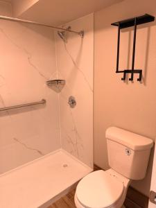 e bagno con servizi igienici bianchi e doccia. di Economy Suites Fort Smith a Fort Smith