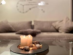 a candle sitting on a table in a living room at Apartment Im Hof by Interhome in Pittenbach