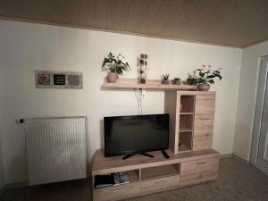 a flat screen tv sitting on a wooden entertainment center at Apartment Im Hof by Interhome in Pittenbach