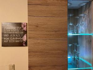 a display of wine bottles in a glass cabinet at Apartment Im Hof by Interhome in Pittenbach