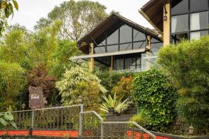 a house with a bunch of plants in front of it at Kood Heritage cottages in Vagamon