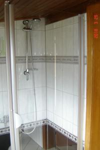 a shower in a bathroom with white tiles at Apartment Santa Maria by Interhome in Nettersheim +7 photos