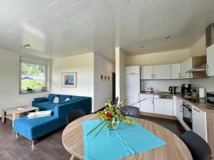 a living room with a blue couch and a table at Apartment Ober Langengarten by Interhome in Pittenbach