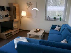 a living room with a blue couch and a table at Apartment Ober Langengarten by Interhome in Pittenbach