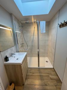 a bathroom with a shower and a sink at Lodges des Pontons - Cap Ouest - vue mer in Saint-Côme-de-Fresné +16 photos
