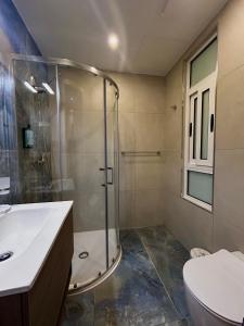 a bathroom with a shower and a toilet and a sink at Tritoni Casa Kappuccini in Il-Furjana +34 photos