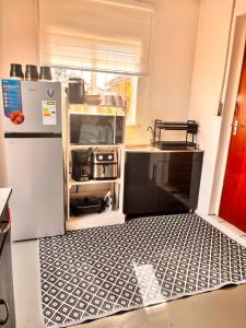 a kitchen with a refrigerator and an open floor at Cape Comfy Hidden Home in Cravenby