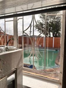 a window with a view of a swimming pool at Cape Comfy Hidden Home in Cravenby