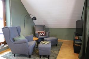 twee stoelen en een kruk in de woonkamer bij Bühler Blick in Bühl