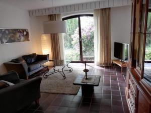 a living room with a couch and a tv at Apartment Schomaker-Fatmann by Interhome in Rastdorf