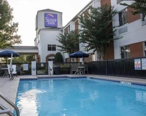 a swimming pool in front of a hotel at Sleep Inn Pelham Oak Mountain in Pelham
