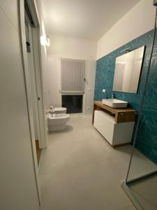 a bathroom with a toilet and a sink and a mirror at Room259 in Treviso