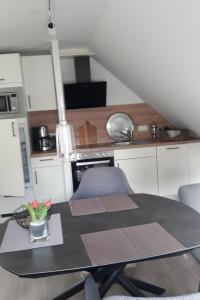 a kitchen with a table and chairs in a room at Apartment Am Wald by Interhome in Westerstede