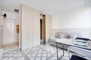 een woonkamer met een tafel en een bank bij Studio cosy - 2P - Bercy in Parijs