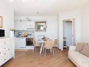 a kitchen and living room with a table and chairs at Apartment 'Cezanne by Interhome in Parzanica