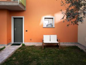 a white chair sitting in front of a house at Apartment 'Cezanne by Interhome in Parzanica
