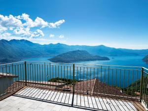 a balcony with a view of a lake and mountains at Apartment 'Cezanne by Interhome in Parzanica