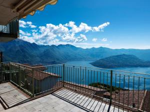 a balcony with a view of a lake and mountains at Apartment 'Cezanne by Interhome in Parzanica