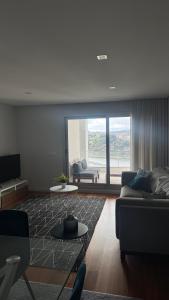 a living room with a couch and a table at Casa Douro in Valbom