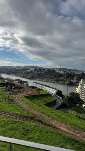 a view of a river with buildings and a city at Casa Douro in Valbom