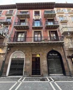 a red brick building with a re reread sign on it at PAMPLONA CENTER SUITES luxury apartament City center in Pamplona