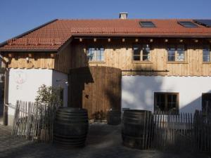 a house with a bunch of barrels in front of it at Apartment Apartment - Monteure by Interhome in Emmering