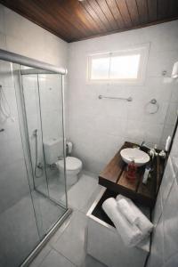 a bathroom with a shower and a toilet and a sink at POUSADA FAMILIAR - Perto do Aeroporto de Salvador in Lauro de Freitas +16 photos