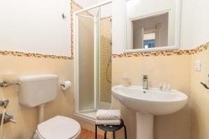 a bathroom with a sink and a toilet and a mirror at Duomo View in Florence