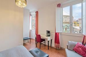 a room with a desk with a computer and a window at Duomo View in Florence +22 photos