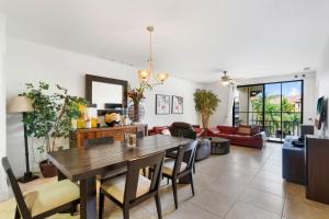 a dining room and living room with a table and chairs at Elegant Condo in High-End Resort Community with Pool and Beach Club Access in Coco