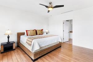 a bedroom with a bed and a ceiling fan at Elegant Condo in High-End Resort Community with Pool and Beach Club Access in Coco +18 photos